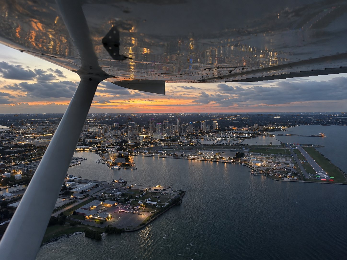 Downtown St. Petersburg at dusk, seen from under the wing of the Cessna 172