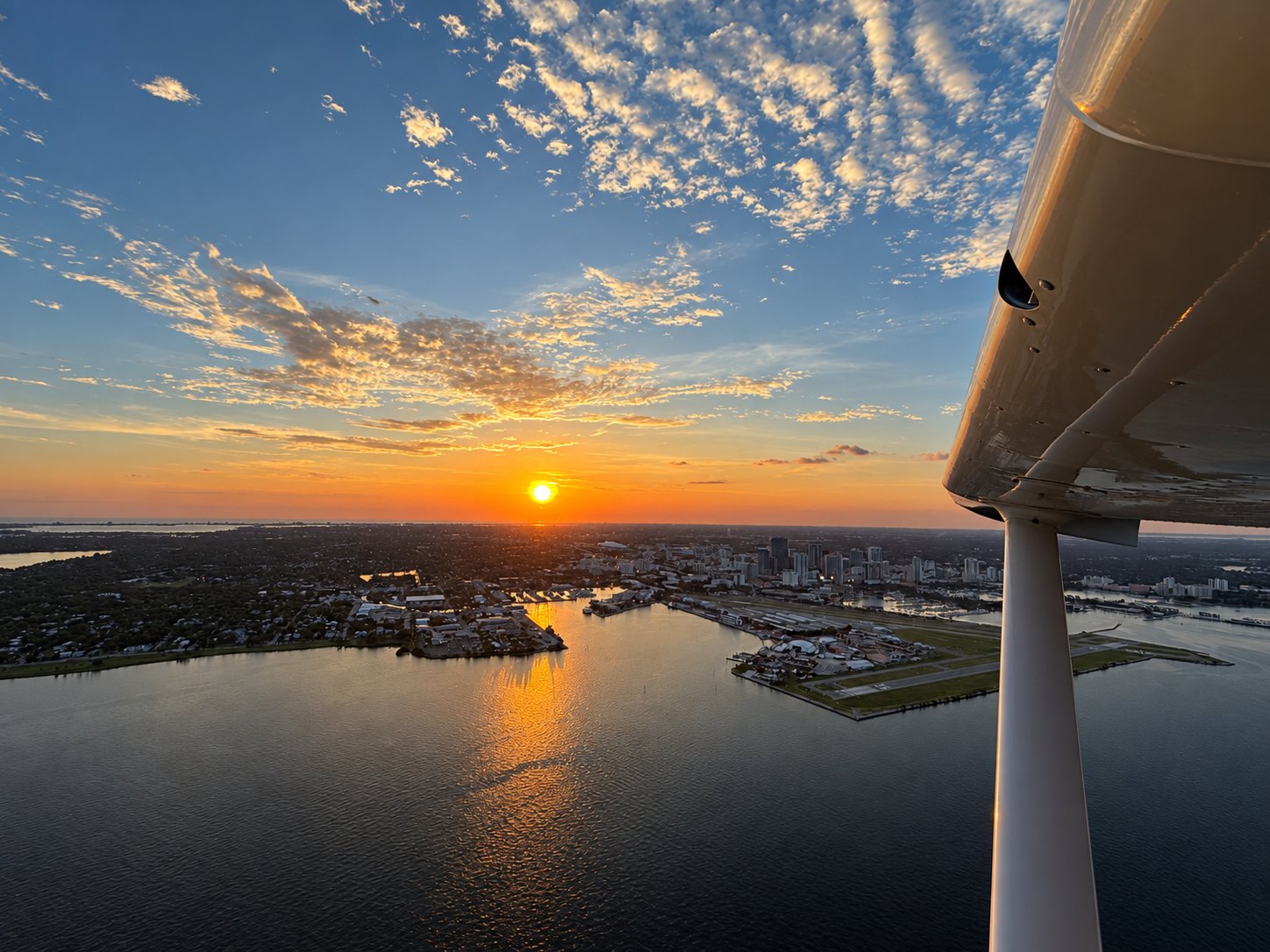 Downtown St. Petersburg at sunset, seen from under the wing of the Cessna 172
